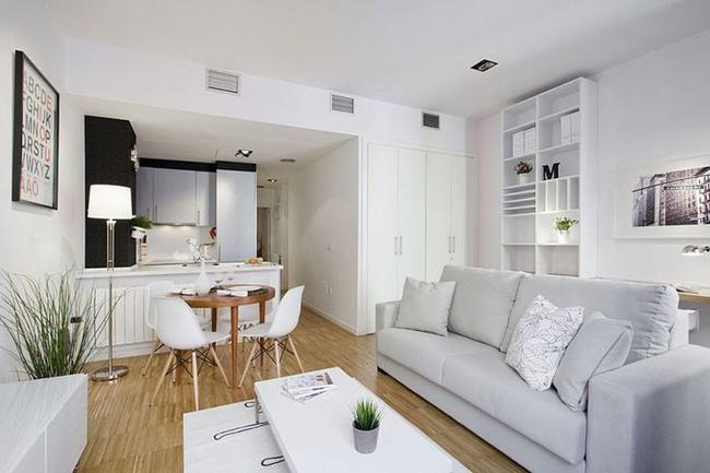 Không gian nhỏ tích hợp phòng bếp, phòng ăn và phòng khách theo phong cách hiện đại lấy gam màu trắng làm gam màu chủ đạo.